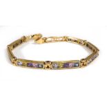 A yellow metal multi gem set tennis bracelet, l. 19 cm, 11.9 gms (af)One section damaged and