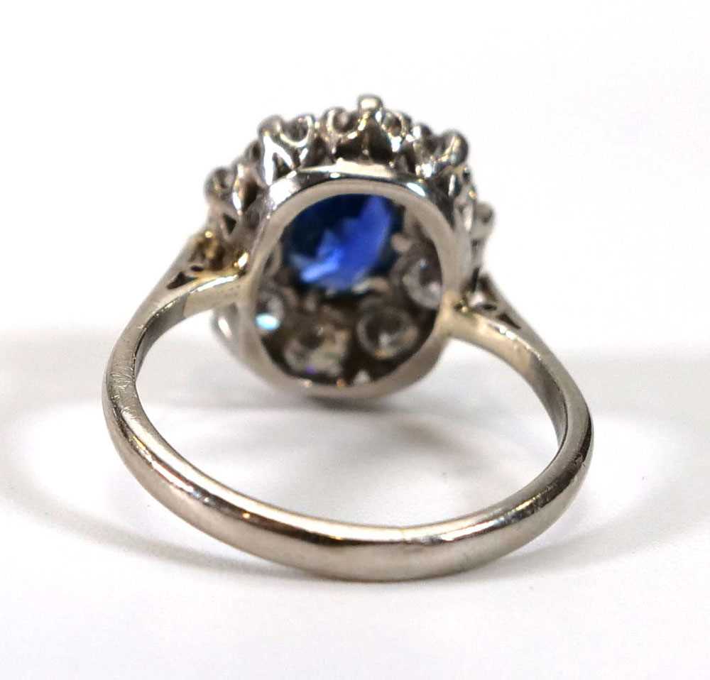 A white metal cluster ring set oval pale blue sapphire within a border of ten brilliant cut - Image 3 of 4