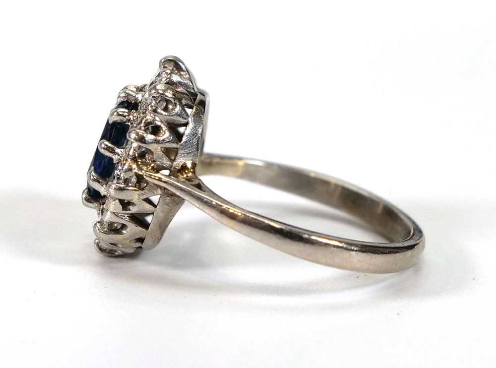 A white metal cluster ring set oval pale blue sapphire within a border of ten brilliant cut - Image 2 of 4