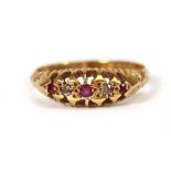 An 18ct yellow gold ring set three small graduated rubies interspersed with two small diamonds in