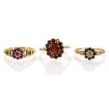 Three 9ct yellow gold cluster rings set ruby, sapphire and garnet, various sizes, overall 6.4 gms (