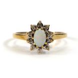 A 9ct yellow gold cluster ring set oval opal within a border of ten small diamonds,ring size N,1.8