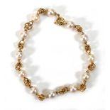 A yellow metal ropetwist necklace set twelve cultured pearls, l. 18 cm, 7.7 gmsWe believe the