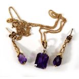 A 9ct yellow gold fine curblink necklace suspending a pendant set rectangular cut amethyst and three