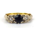 An 18ct yellow gold ring set round cut sapphire and two small diamonds in illusion settings, ring