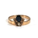 A yellow metal ring set oval sapphire and nine small diamonds in a coronet style setting, ring