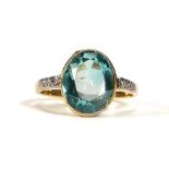 An 18ct yellow gold and platinum highlighted ring set oval natural pale blue zircon in a rubover