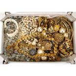 A group of costume jewellery including gold coloured necklaces, ear clips, brooches, beaded