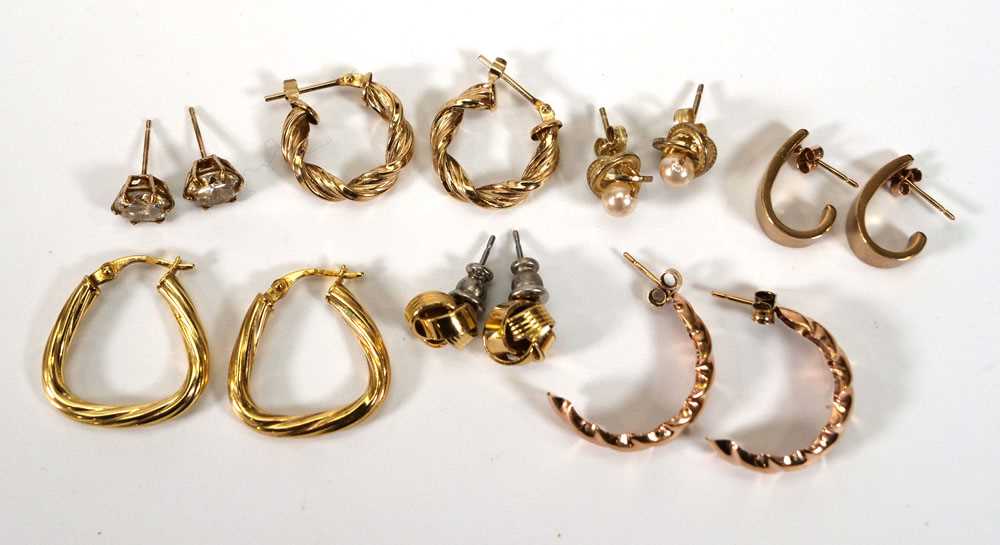 A pair of 9ct yellow gold ear hoops and six further pairs of yellow metal and gold coloured earrings