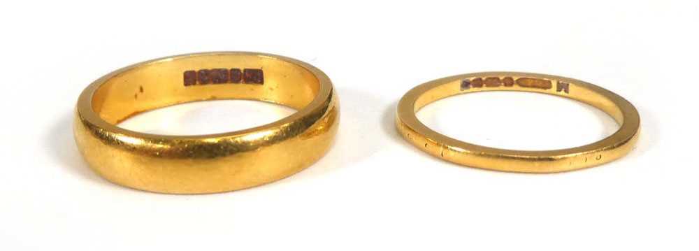 Two 22ct yellow gold wedding bands, ring sizes K 1/2 and M,overall 7.1 gms (2)