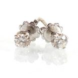 A pair of 18ct white gold ear studs, each set a brilliant cut diamond in a four claw setting,