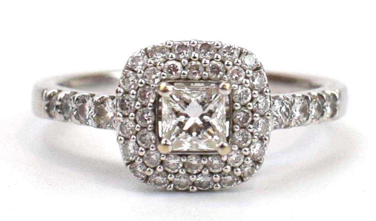 An 18ct white gold halo ring set centrally with a princess cut diamond within a double border of