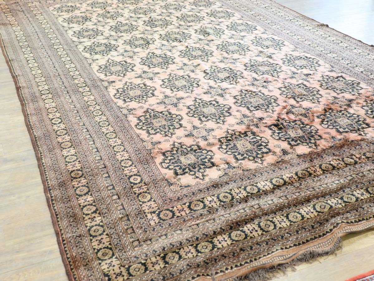 An Afghan carpet, circa 1940/50's, woven in the stylised Turkmenistan style, the red ground with - Image 2 of 5