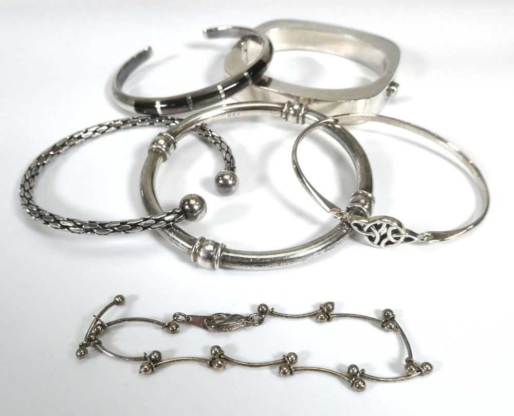 Six silver and metalware bracelets and bangles including a Mexican example, another of Celtic design