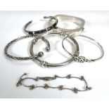 Six silver and metalware bracelets and bangles including a Mexican example, another of Celtic design