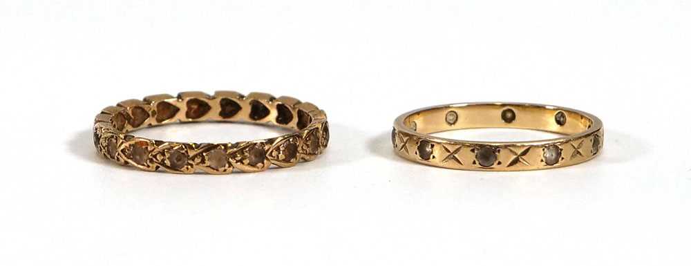 Two 9ct yellow gold eternity ring set paste, ring sizes N and Q, overall 3.3 gms (2)