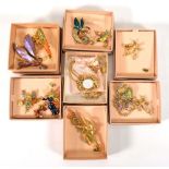 Twelve items of Kirks Folly enamelled brooches including fairy and naturalist examples, contained in