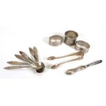 A group of silver comprising three napkin rings,a set of six filigree work teaspoons, a pair of