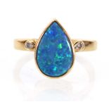A 9ct yellow gold ring set teardrop blue opal and two small diamonds within rubover settings,ring