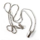 A 9ct white gold boxlink necklace suspending an elongated pendant set four small diamonds in tension