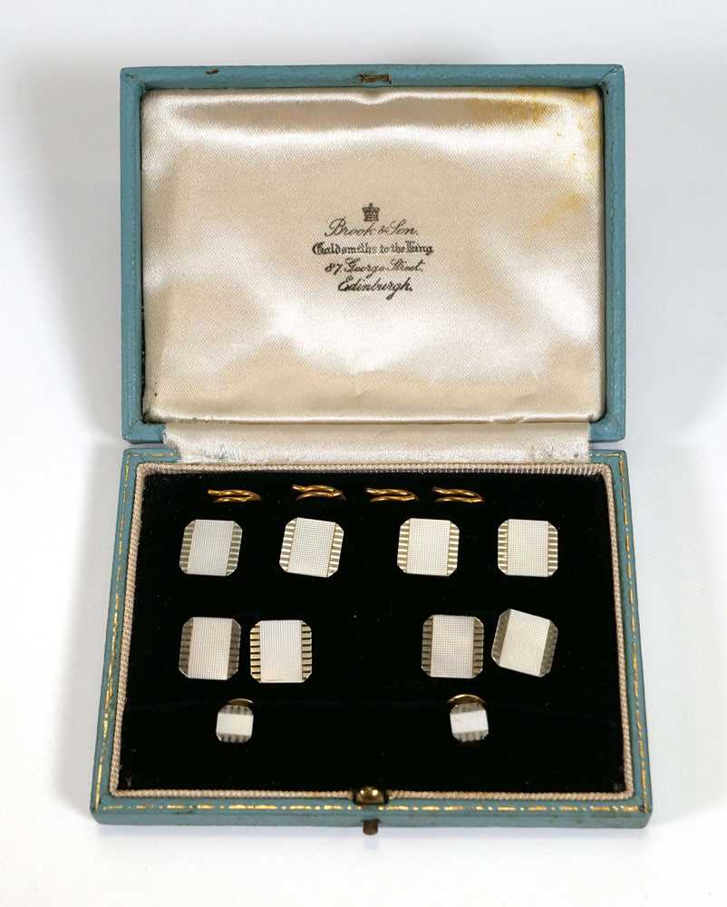 A set of 9/18ct yellow and white gold engined turned dress studs, each decorated with mother of