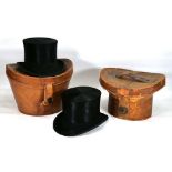 A Victorian leather hat boxes containing a silk top hat by R. Womack, together with another