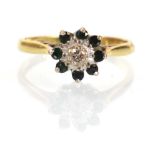 An 18ct yellow gold cluster ring set small diamond within a border of eight emeralds,ring size N,2.9