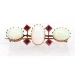 An early 20th century 9ct yellow gold bar brooch set three oval opals interspersed with four