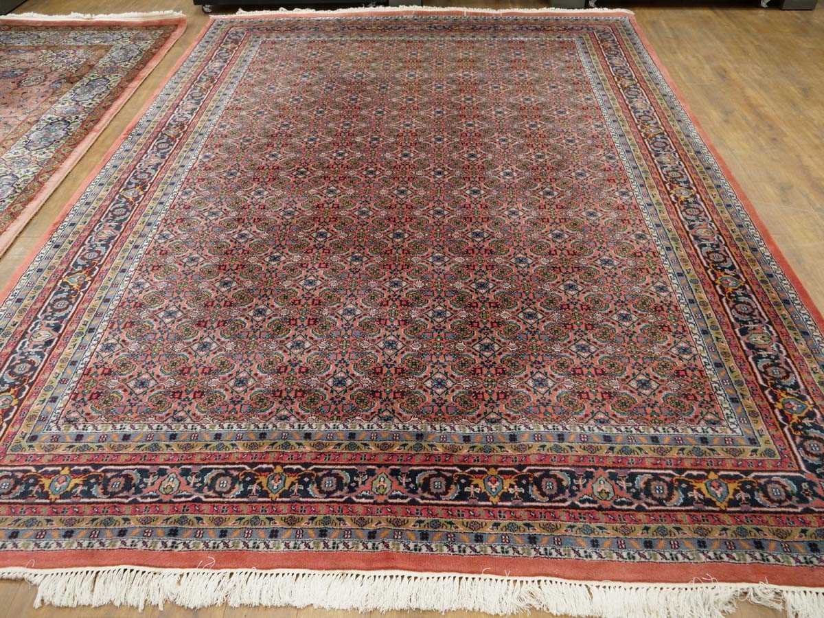 An Iranian carpet with an orange and blue ground, 350 x 250 cm