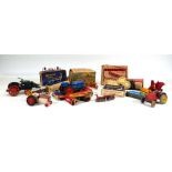 A collection of Britains farmyard models including tractors, rakes, ploughs and other implements,