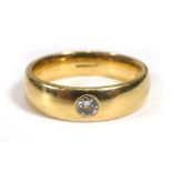 An 18ct yellow gold ring set brilliant cut diamond in a recessed rubover setting,stone approx. 0.