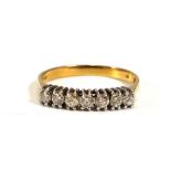 An 18ct yellow gold ring set seven small diamonds in an in-line setting,ring size M 1/2,2.1 gms