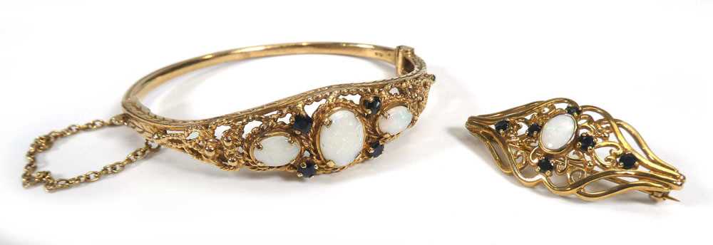 A 19th century style 9ct yellow gold hinged bracelet and a matching brooch, each set opals and