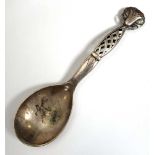 A Georg Jensen Danish silver serving spoon, model no. 83, with foliate finial and openwork handle,