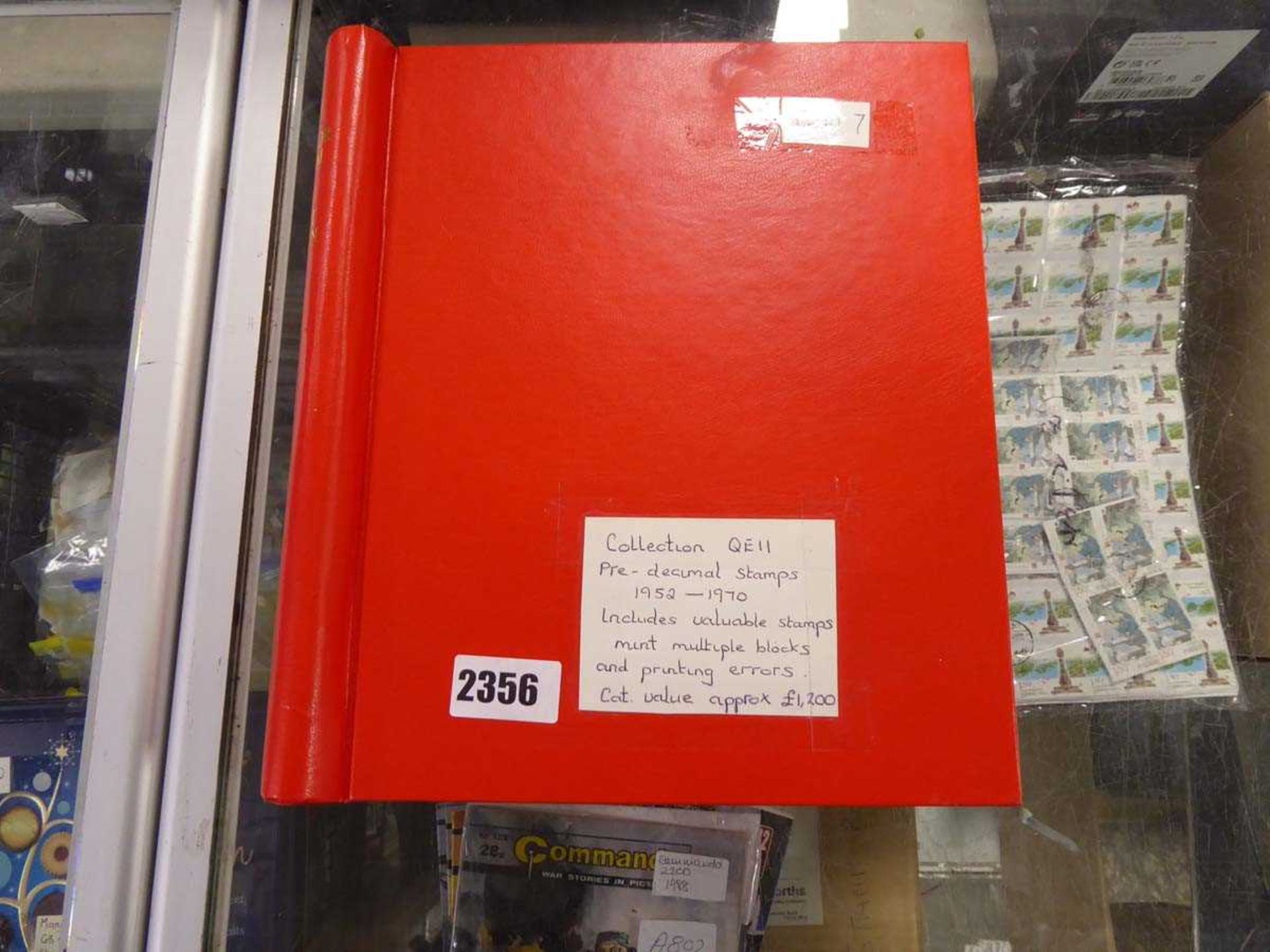 Red stamp stockbook containing collection of QE2 pre-decimal stamps 1952-1970