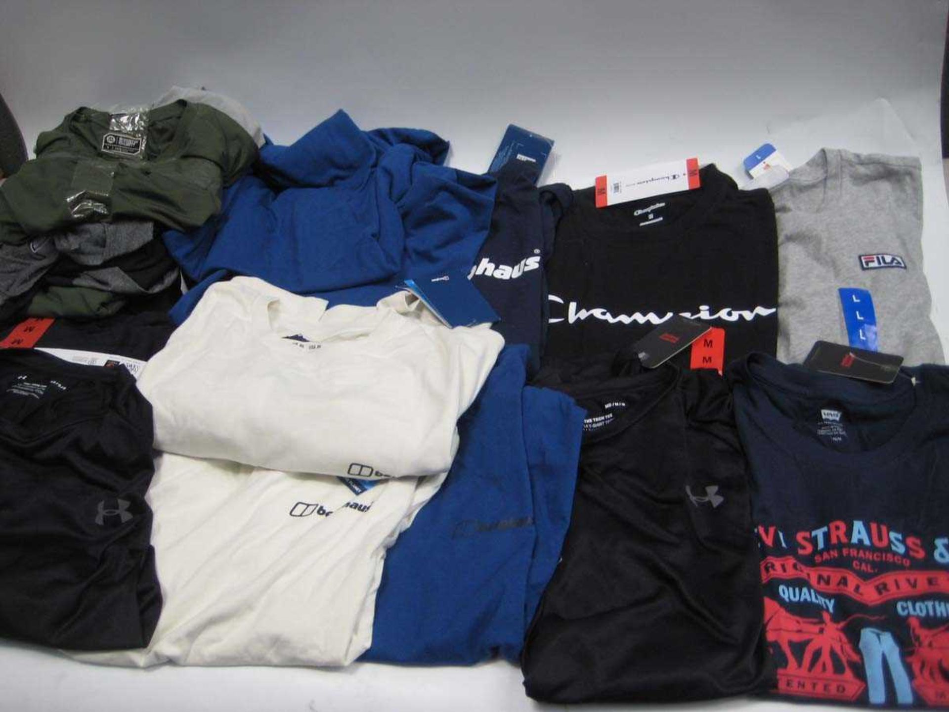 +VAT A bag containing Men's T Shirts in various styles and sizes, including Levi, Under Armour,