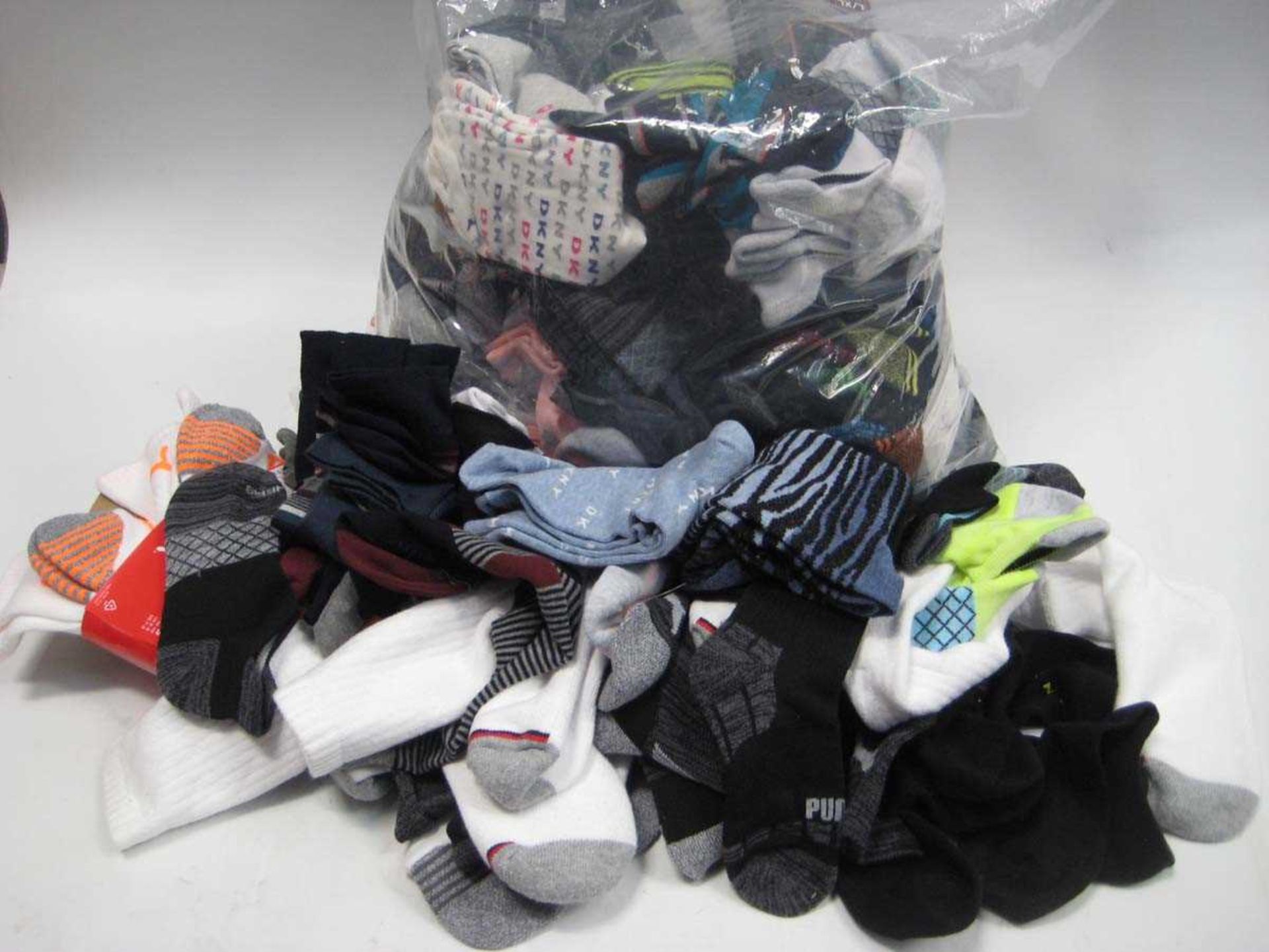 +VAT A bag containing a large quantity of Men's and Ladies socks in various sizes, including DKNY,