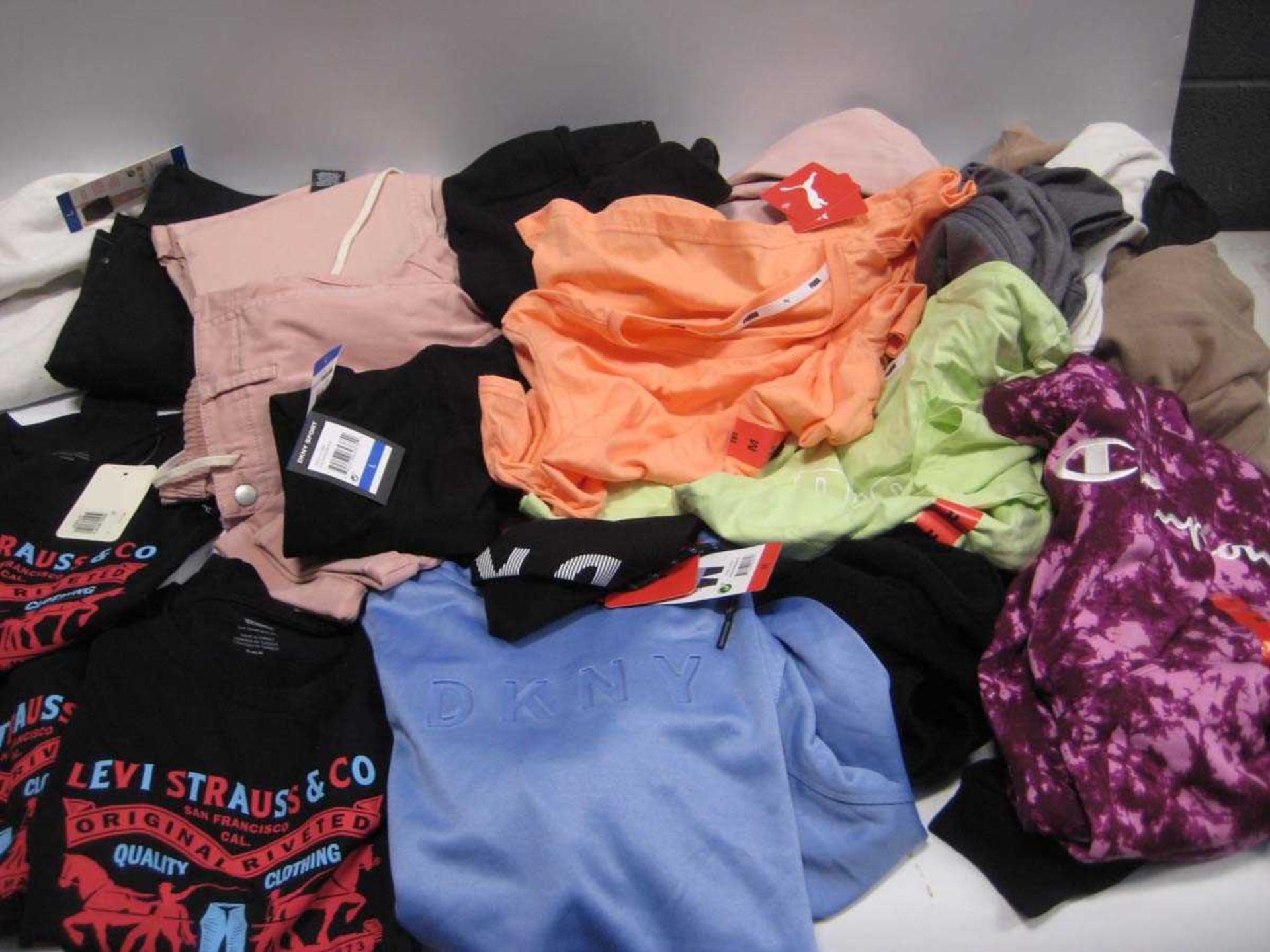 +VAT A bag containing Ladies Clothing in various styles and sizes, including Levis, Champion,