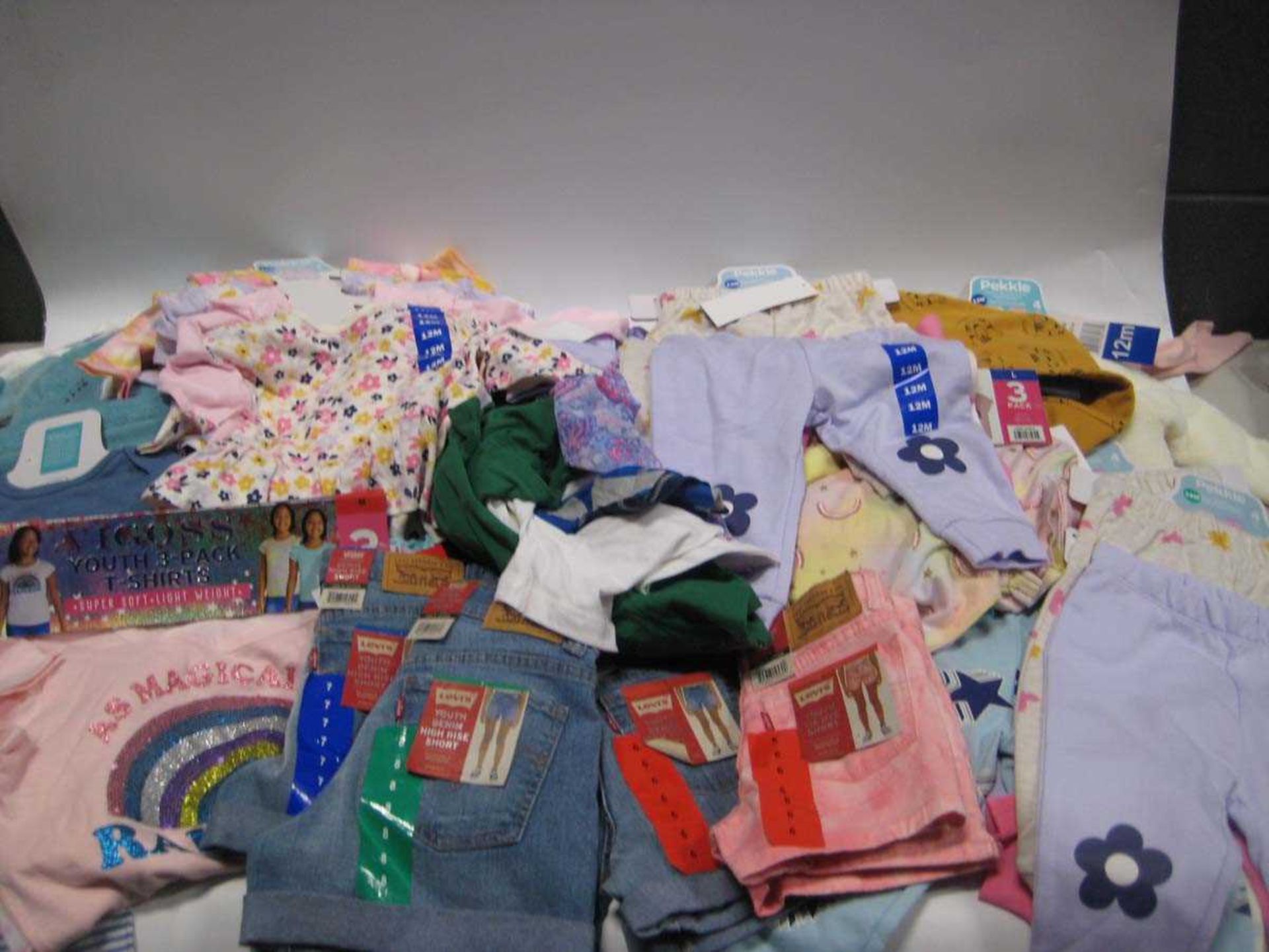 A bag containing Children's Clothing in various styles and sizes, including Levis