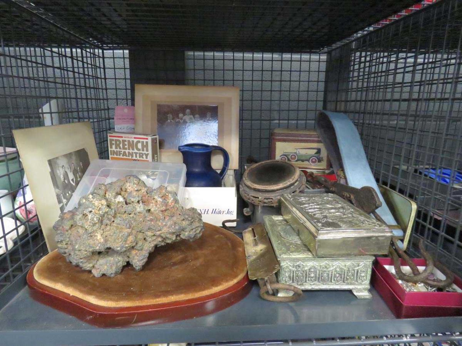 Cage containing photographs, buttons, costume jewellery and rock example