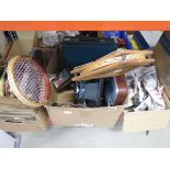 Box containing vintage tennis rackets, oil can, cameras and a car cassette player