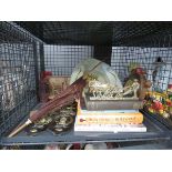 Cage containing a bedpan, barometer, parasol, bear figures, books and horse brasses