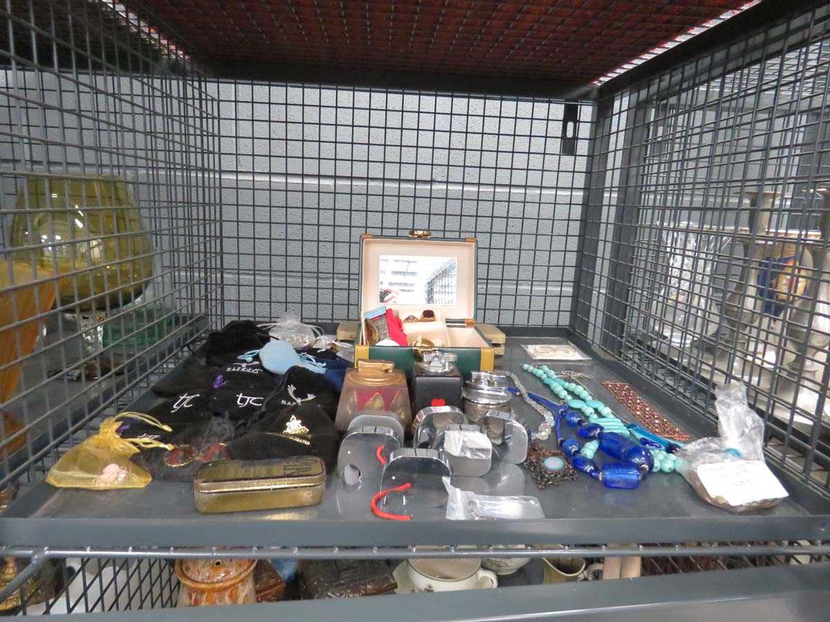 Cage containing costume jewellery and table lighters