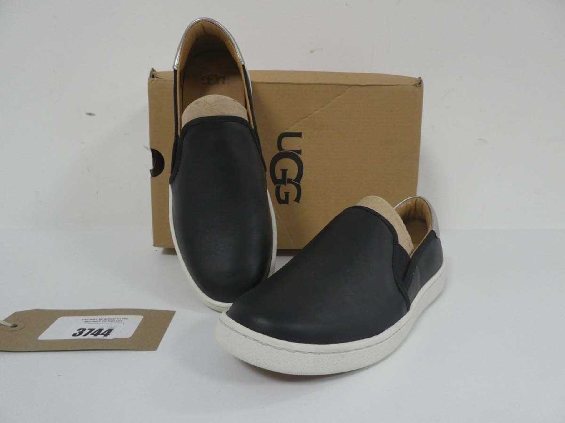 +VAT Boxed pair of UGG slip on shoes in black / silver size UK5