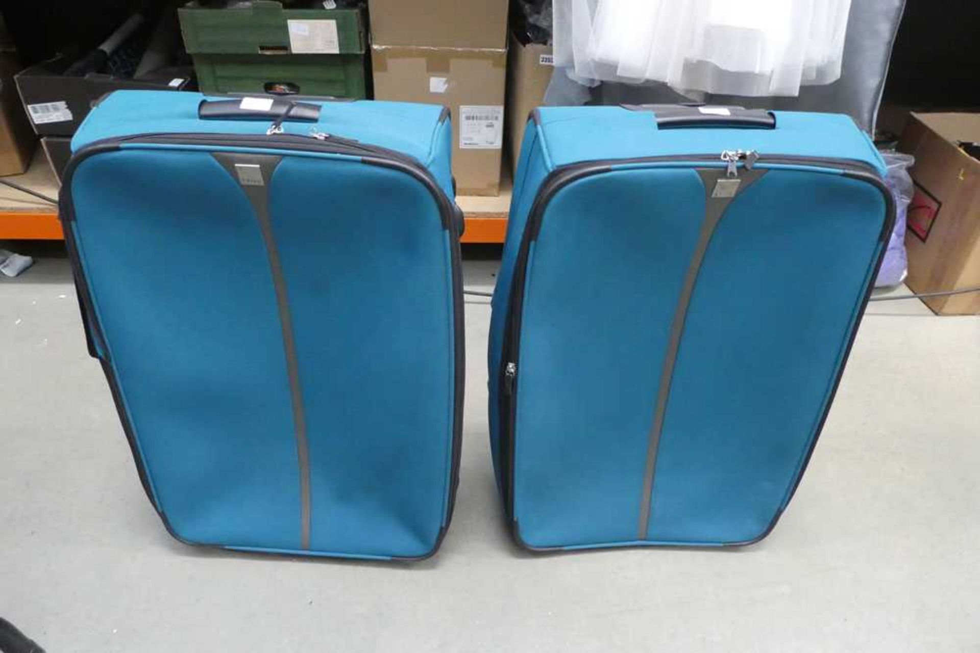 2 large green fabric suitcases