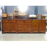 Reproduction mahogany sideboard with central drawers and cupboards to the side