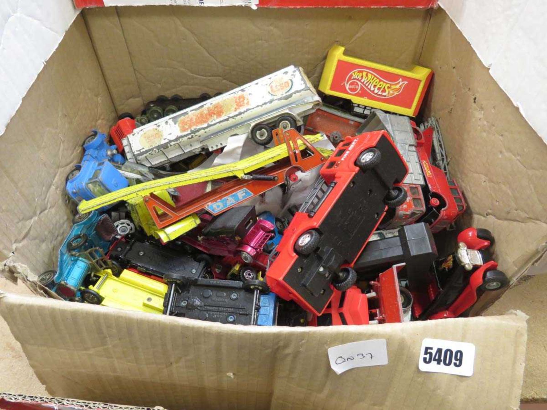 Box containing plastic and die cast toy cars