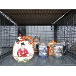 Cage containing beer steins, ornamental jug and cottage teapot