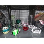 Cage containing glass baskets, vases and paperweights