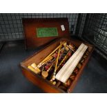Cage containing vintage table croquet set